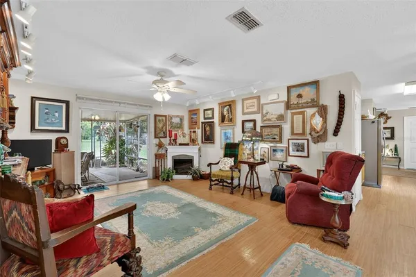 a living room with furniture a fireplace and a large window