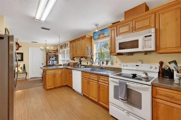 a kitchen with stainless steel appliances granite countertop a stove and a sink