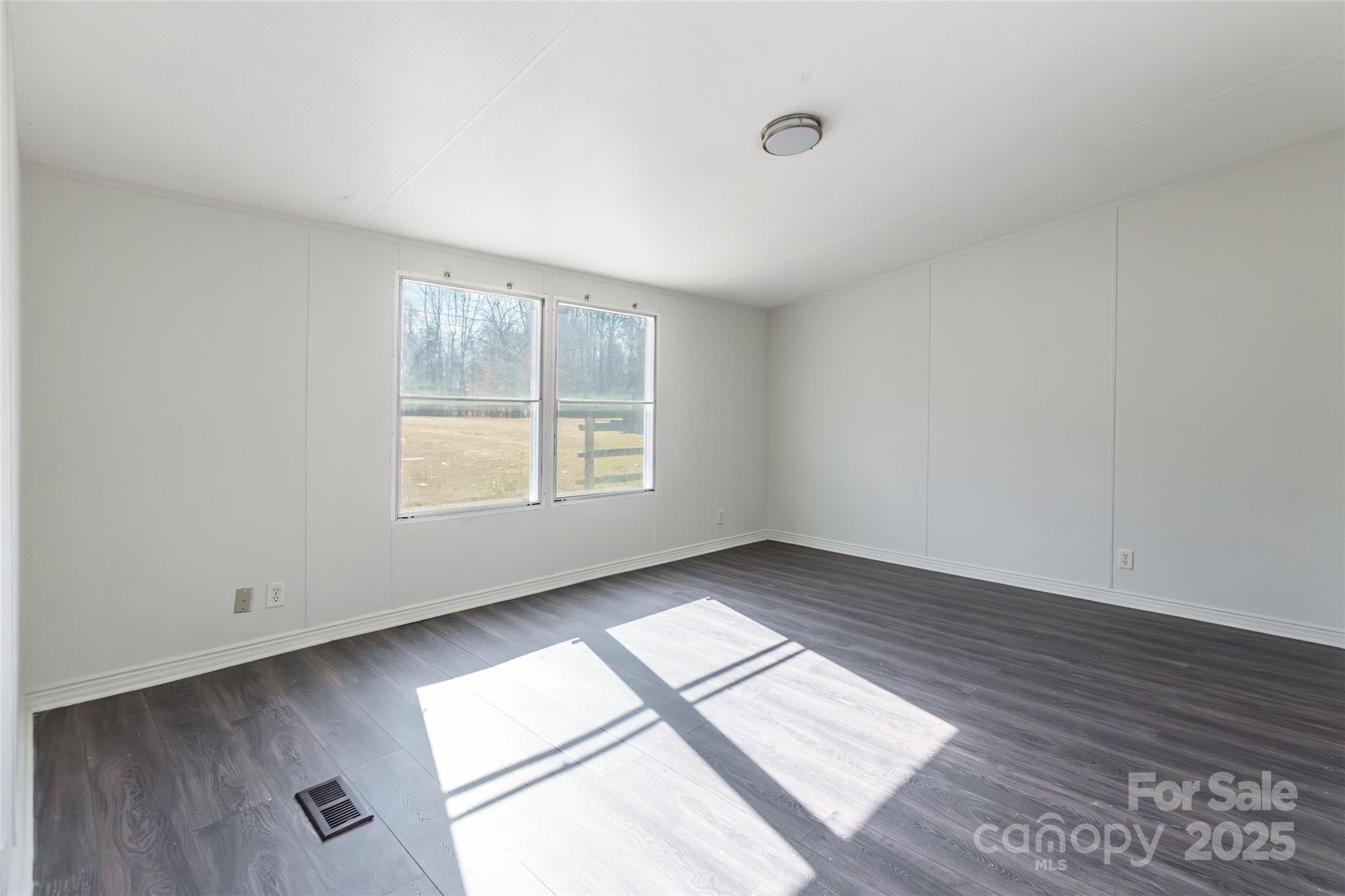 6315 Wingate Hill Road Denver, NC 28037 - Photo 15 of 21 an empty room with wooden floor and windows