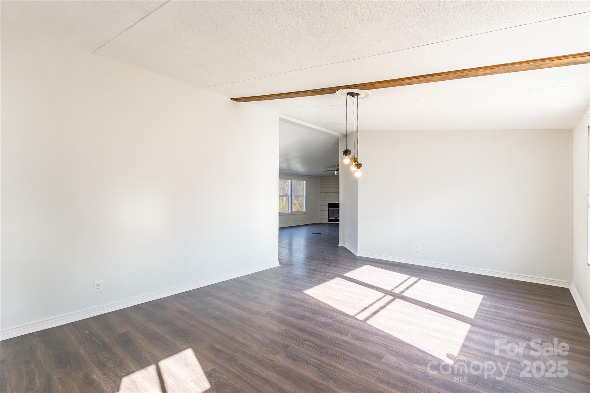 6315 Wingate Hill Road Denver, NC 28037 - Photo 3 of 21 a view of empty room with wooden floor and fan
