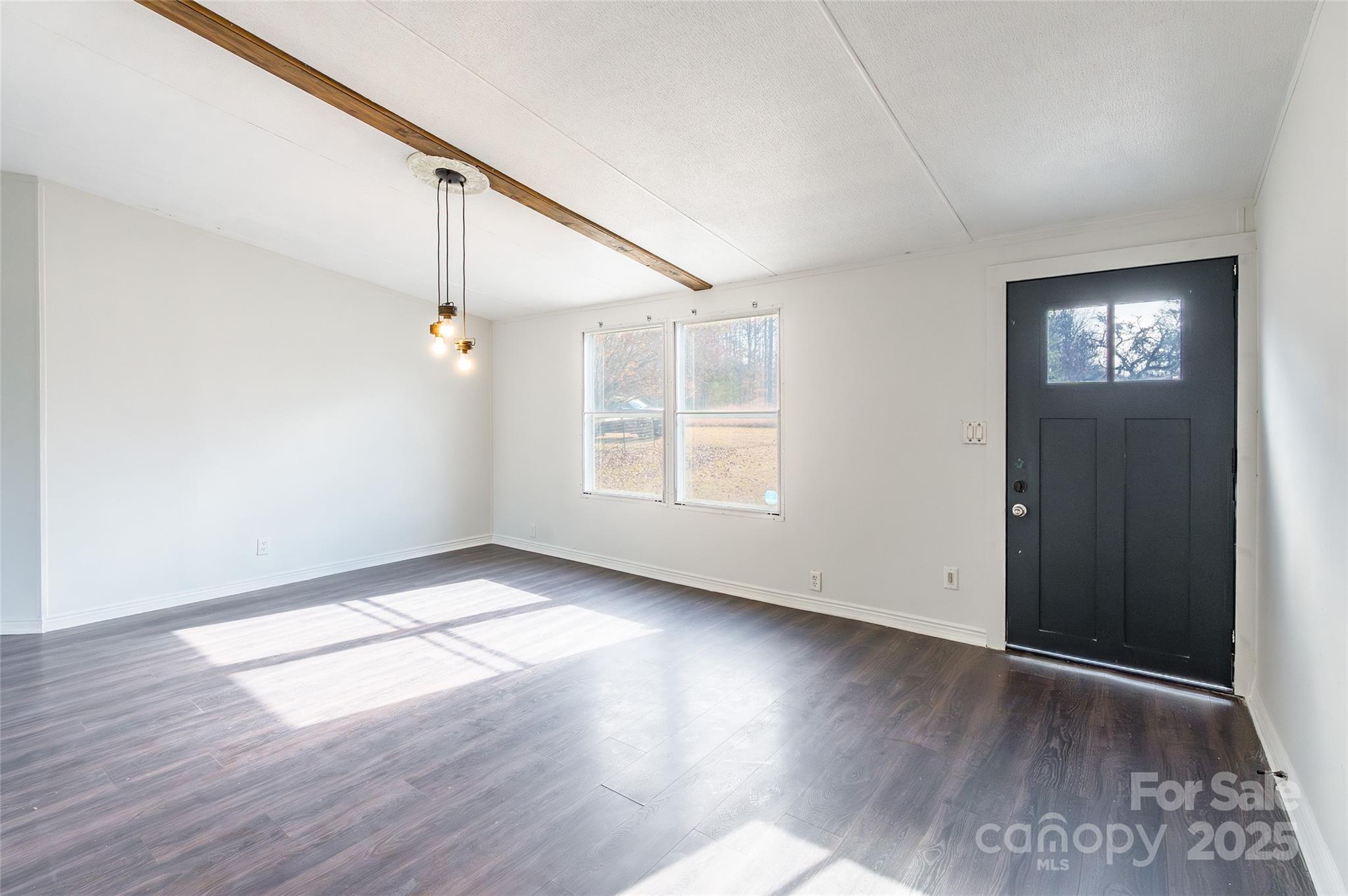 6315 Wingate Hill Road Denver, NC 28037 - Photo 4 of 21 an empty room with wooden floor fan and windows