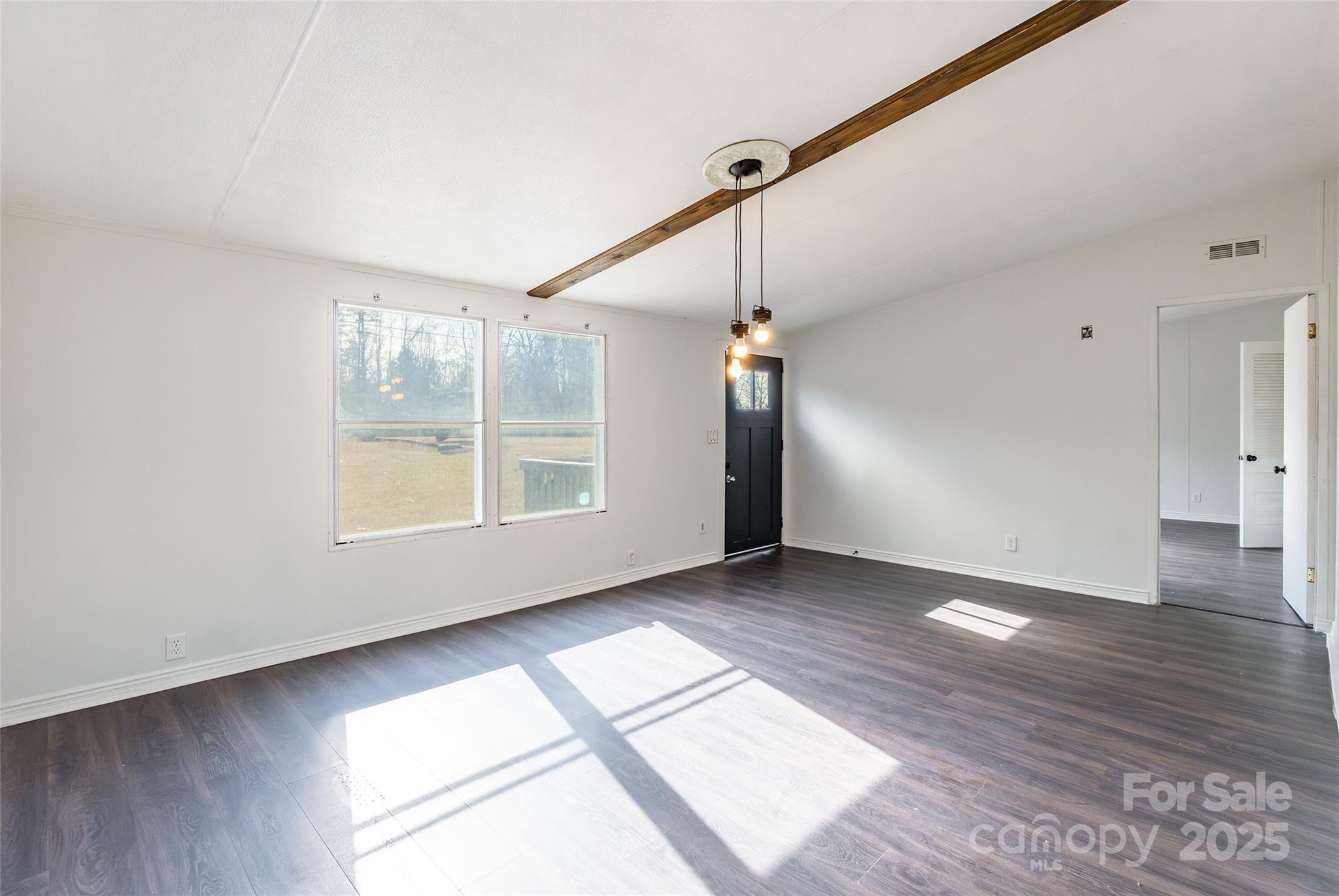 6315 Wingate Hill Road Denver, NC 28037 - Photo 5 of 21 an empty room with wooden floor fan and windows