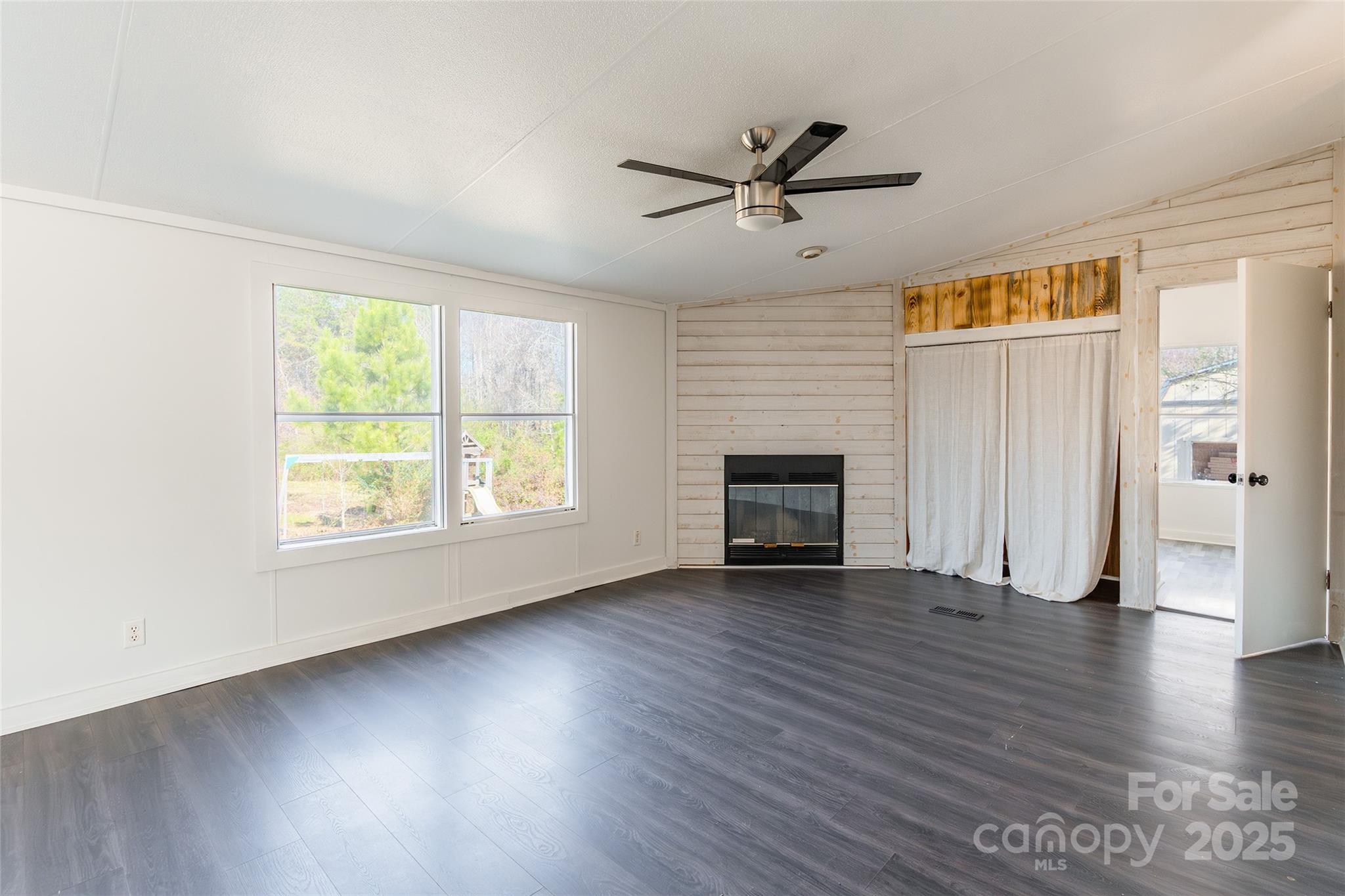 6315 Wingate Hill Road Denver, NC 28037 - Photo 9 of 21 an empty room with wooden floor fan and windows