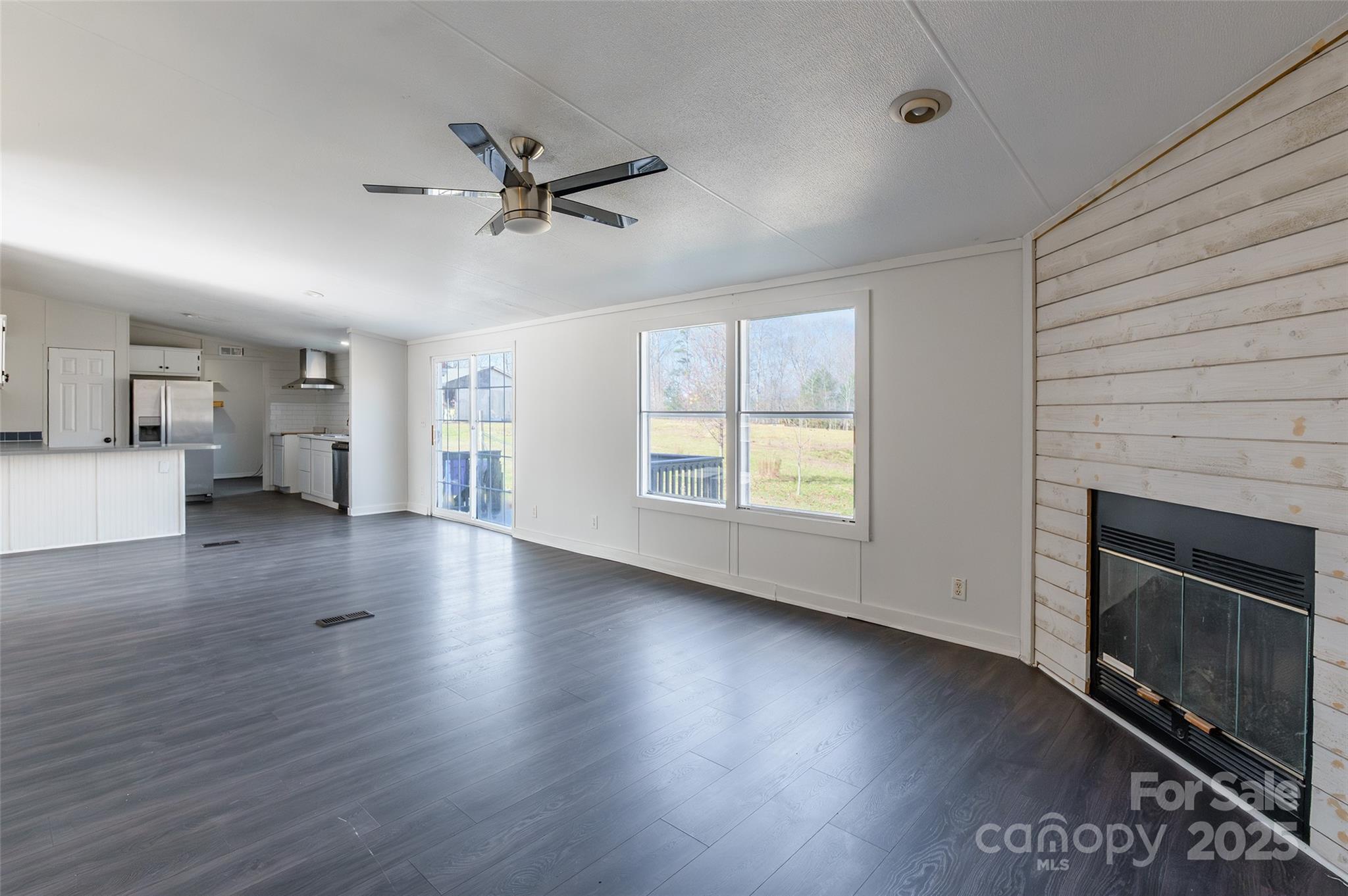 6315 Wingate Hill Road Denver, NC 28037 - Photo 10 of 21 a view of an empty room with a fireplace and a window