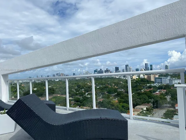 a roof deck with table and chairs potted plants