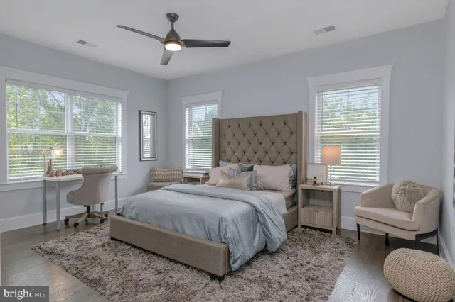 a spacious bedroom with a bed and a window