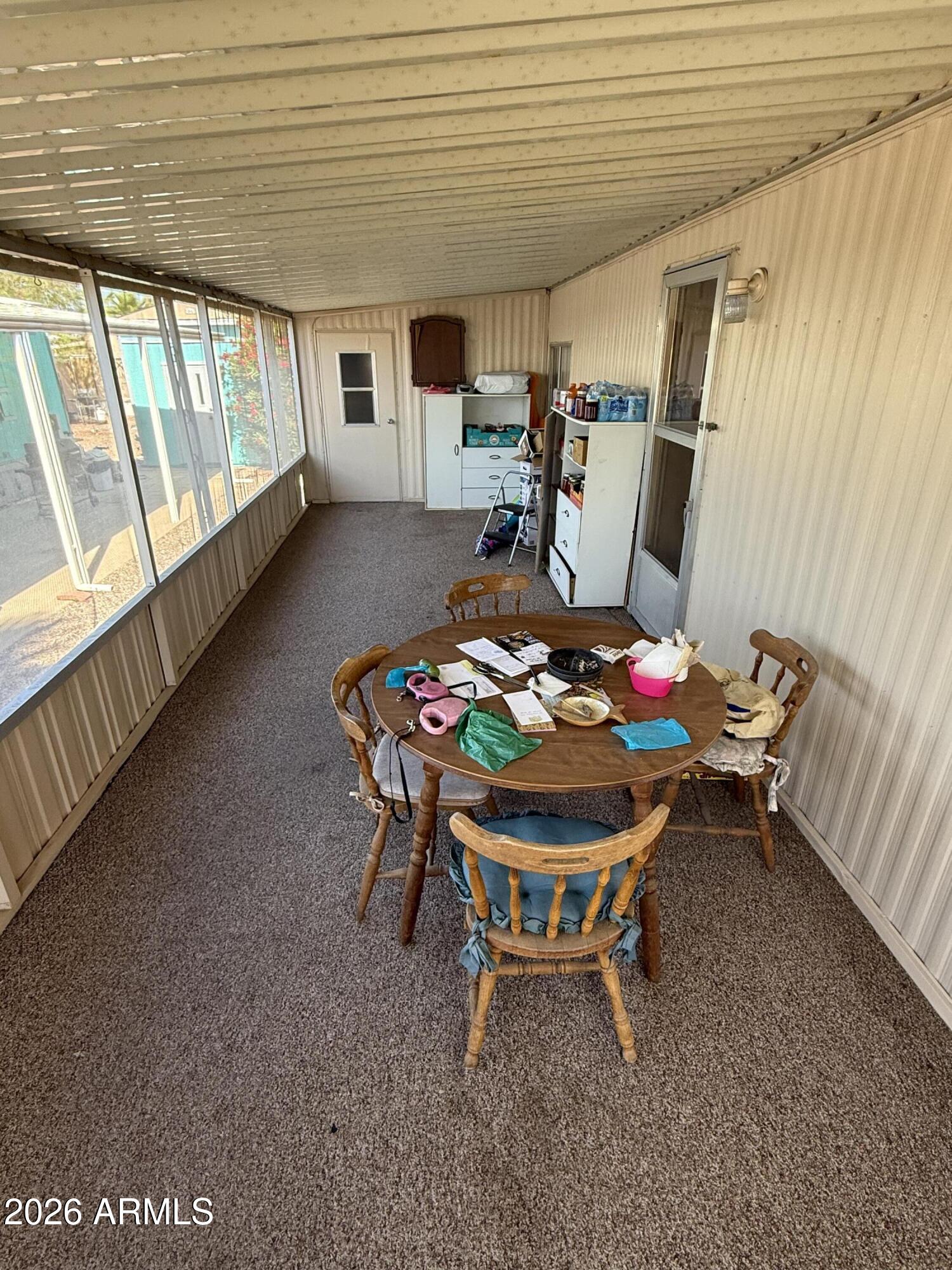 9501 East Broadway Road, Unit 164 Mesa, AZ 85208 - Photo 2 of 27 a dining room with furniture and a floor to ceiling window