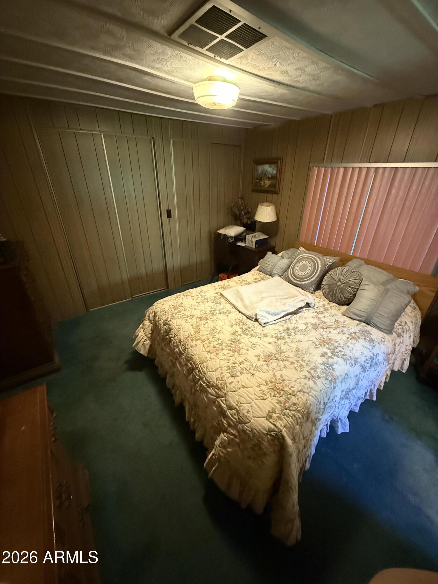 9501 East Broadway Road, Unit 164 Mesa, AZ 85208 - Photo 21 of 27 a bed sitting in a bedroom next to a window