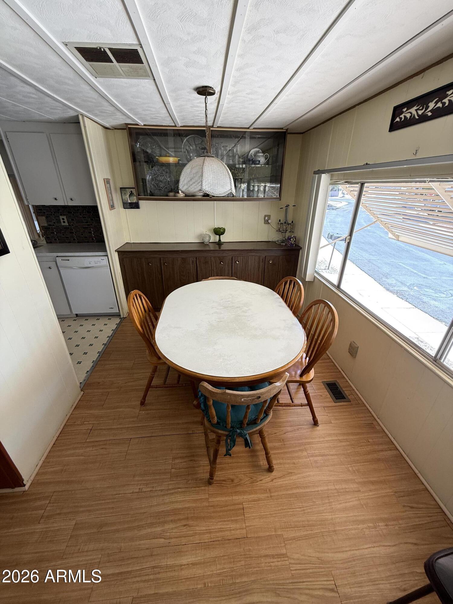 9501 East Broadway Road, Unit 164 Mesa, AZ 85208 - Photo 4 of 27 a view of a kitchen with furniture window and wooden floor