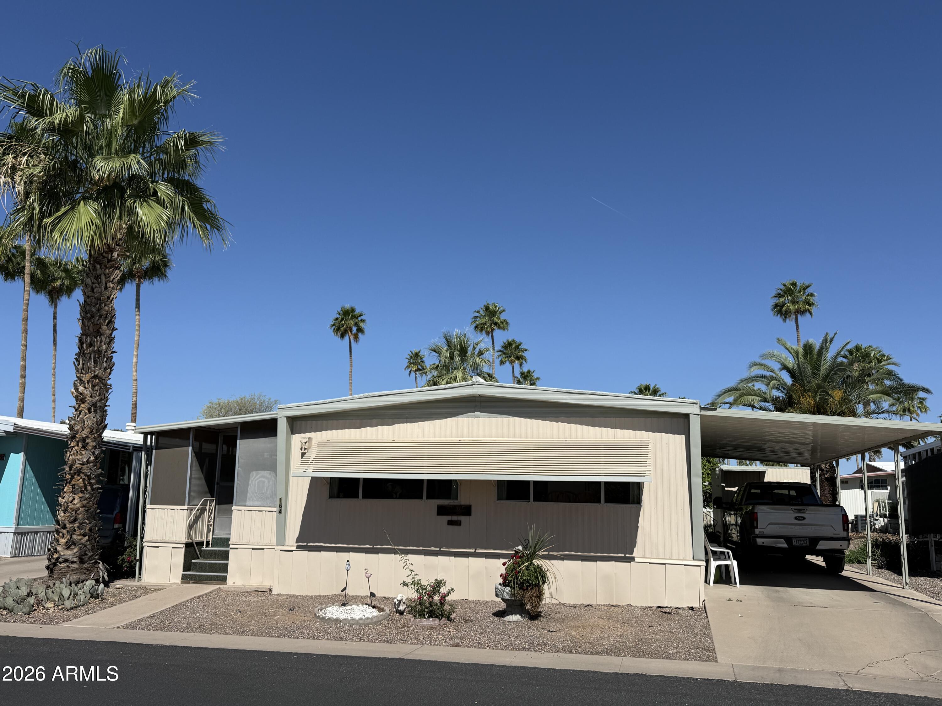 9501 East Broadway Road, Unit 164 Mesa, AZ 85208 - Photo 5 of 27 a front view of a house with garden