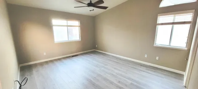 wooden floor in an empty room with a window