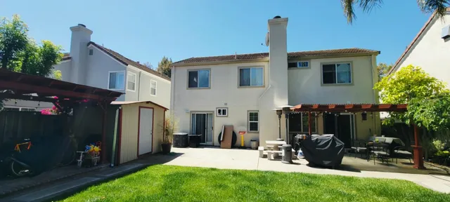 a view of backyard with wheel chair and potted plants