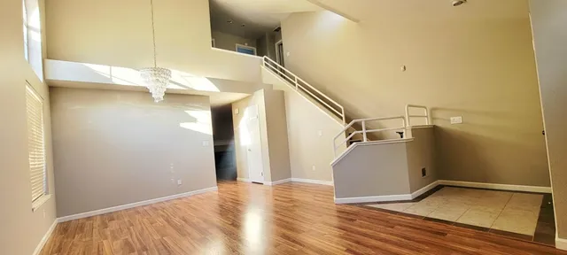 a view of a room with wooden floor and staircase