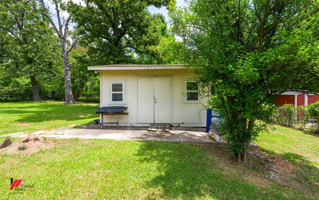 3109 Gorton Road Shreveport, LA 71119 - Photo 30 of 31 a view of a backyard with table and chairs and potted plants and large trees