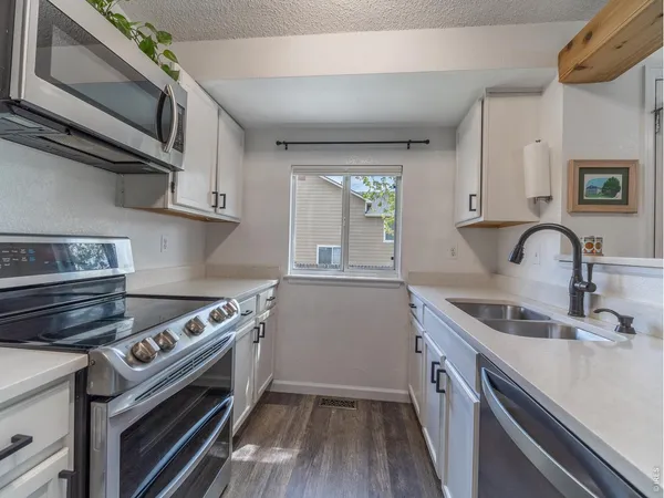a kitchen with a sink stove and cabinets
