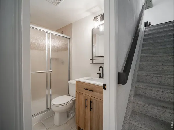 a bathroom with a toilet a sink and shower