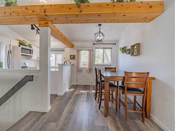 a view of a dining room with furniture and wooden floor