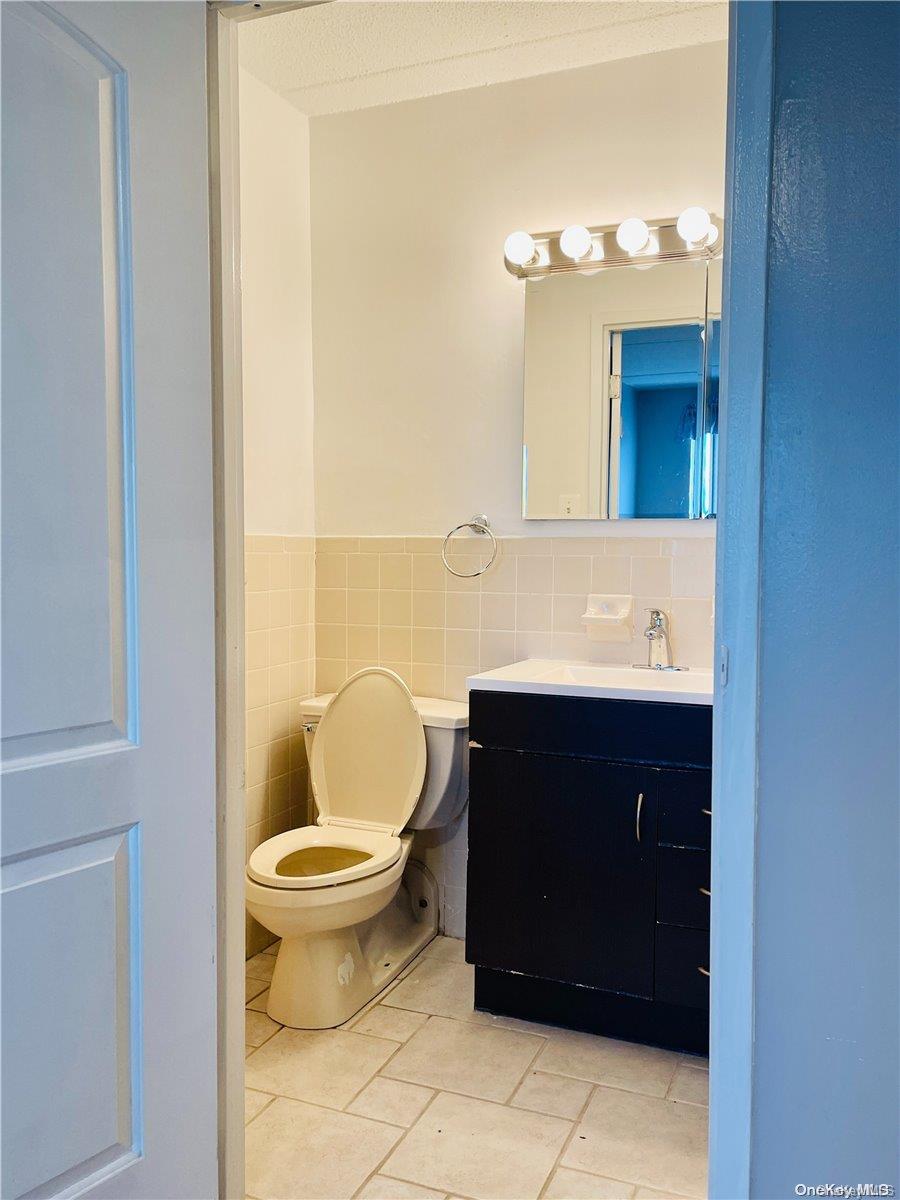 92-29 Queens Boulevard, Unit 9D Queens, NY 11374 - Photo 12 of 13 a bathroom with a sink and a toilet