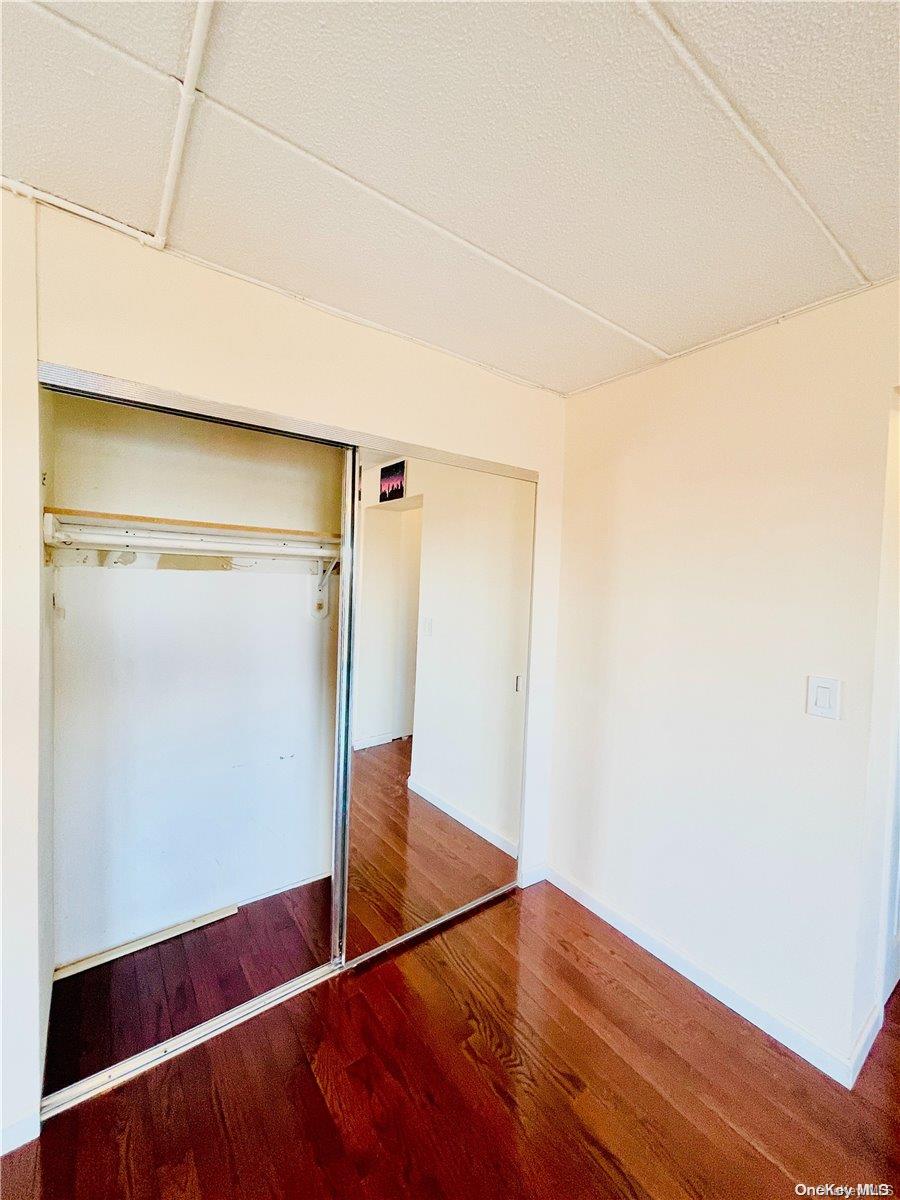 92-29 Queens Boulevard, Unit 9D Queens, NY 11374 - Photo 6 of 13 a view of empty room with wooden floor