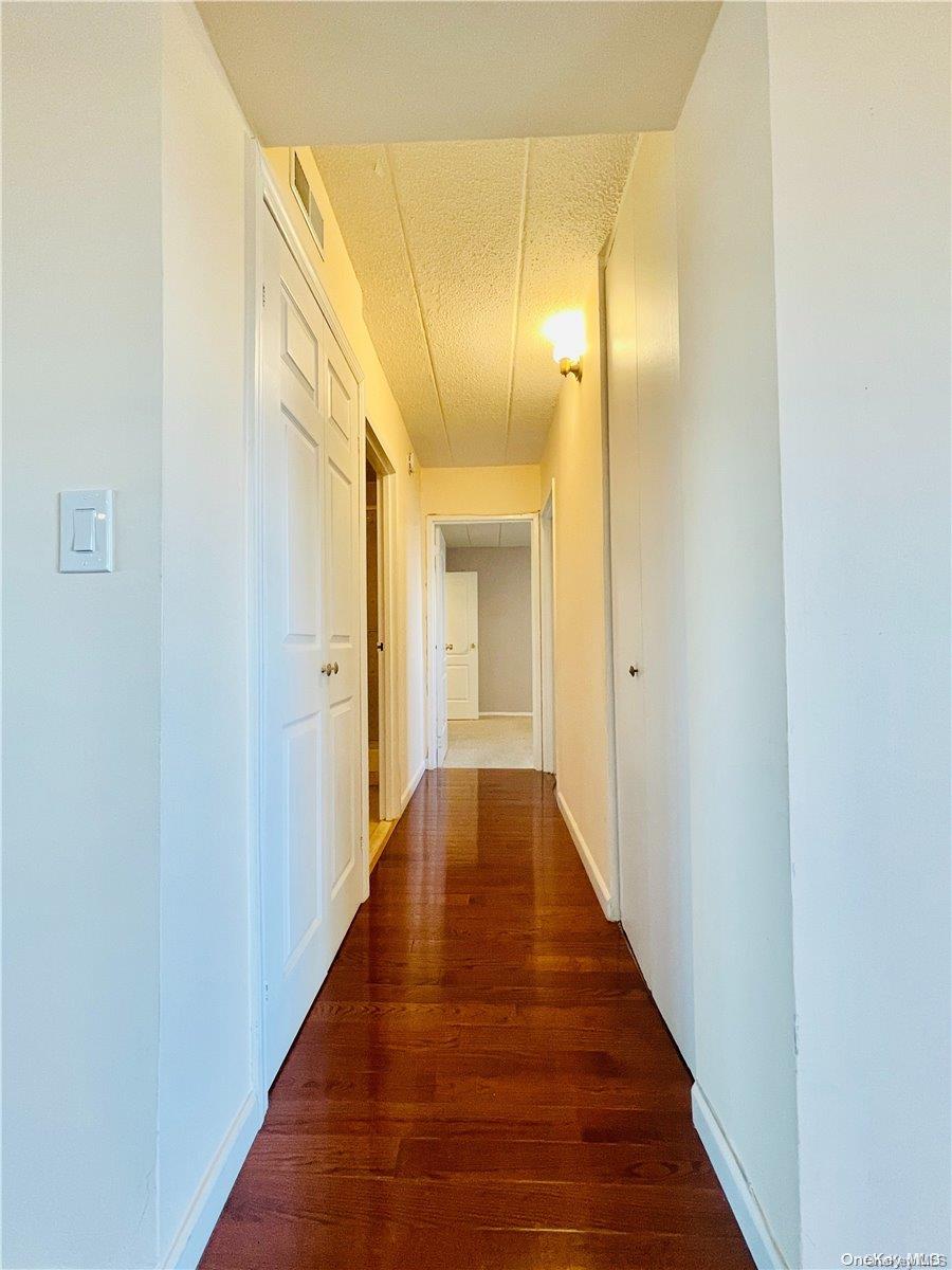 92-29 Queens Boulevard, Unit 9D Queens, NY 11374 - Photo 7 of 13 a view of a hallway with wooden floor