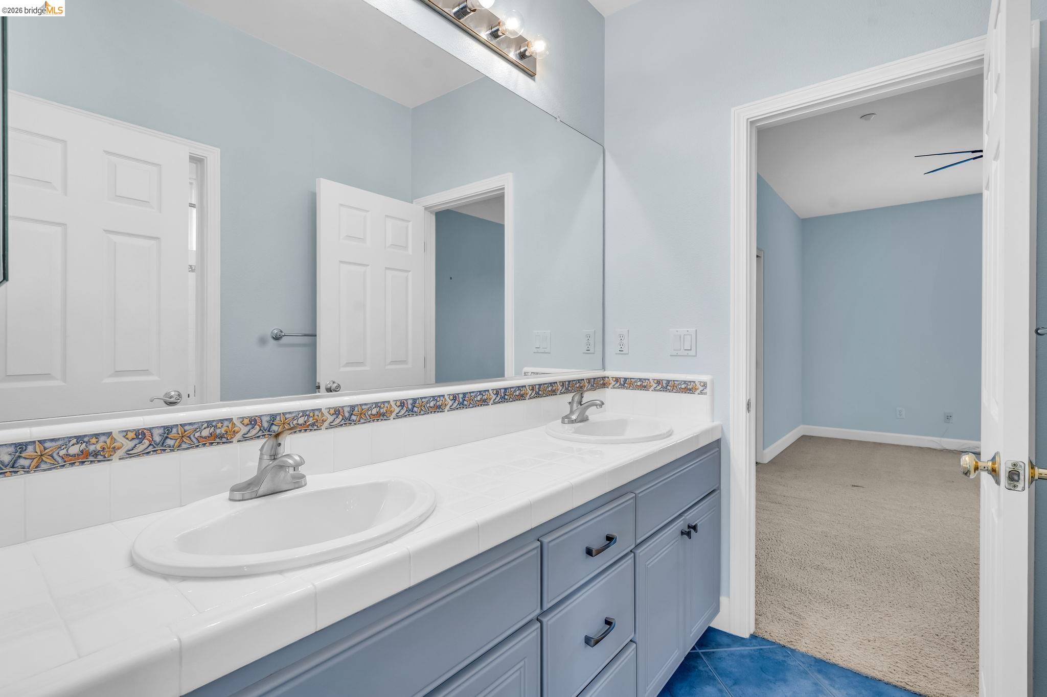 5 Circle E Ranch Place San Ramon, CA 94583 - Photo 41 of 60 a bathroom with double sink and a mirror