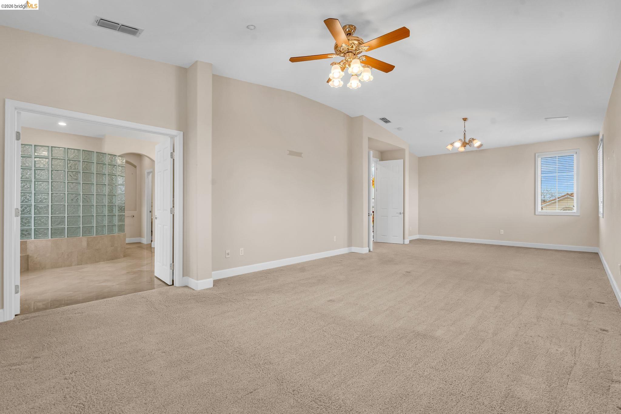 5 Circle E Ranch Place San Ramon, CA 94583 - Photo 42 of 60 Unfurnished room with carpet, a ceiling fan, arched walkways, and suspended lighting