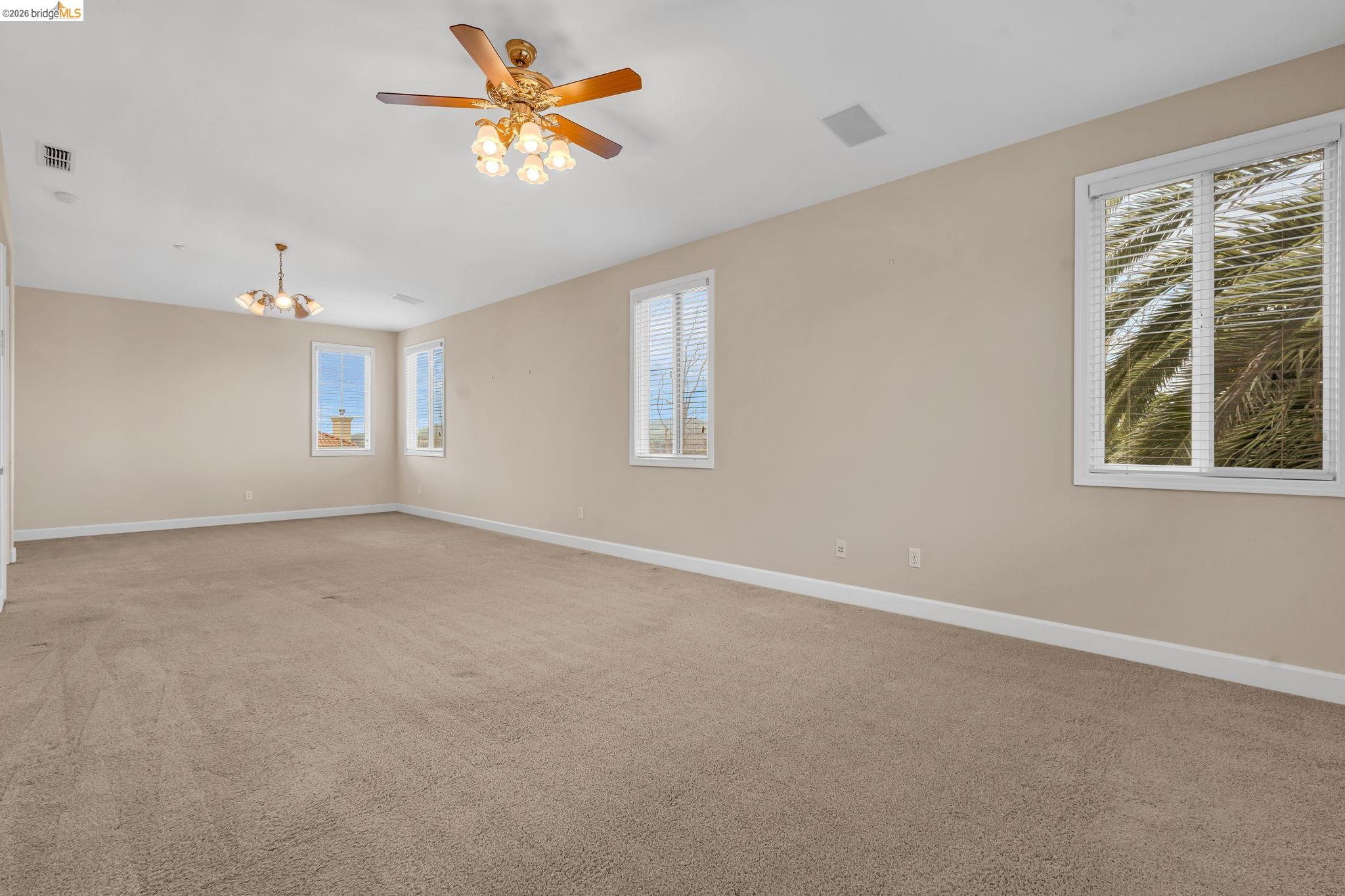 5 Circle E Ranch Place San Ramon, CA 94583 - Photo 43 of 60 Spare room featuring light colored carpet, ceiling fan, and suspended lighting