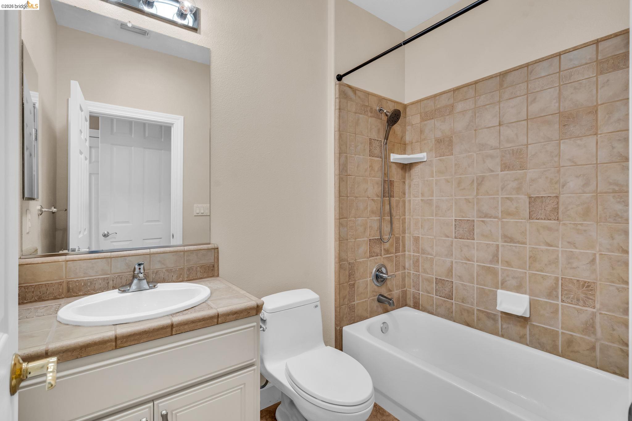 5 Circle E Ranch Place San Ramon, CA 94583 - Photo 55 of 60 a bathroom with a granite countertop sink toilet mirror and shower