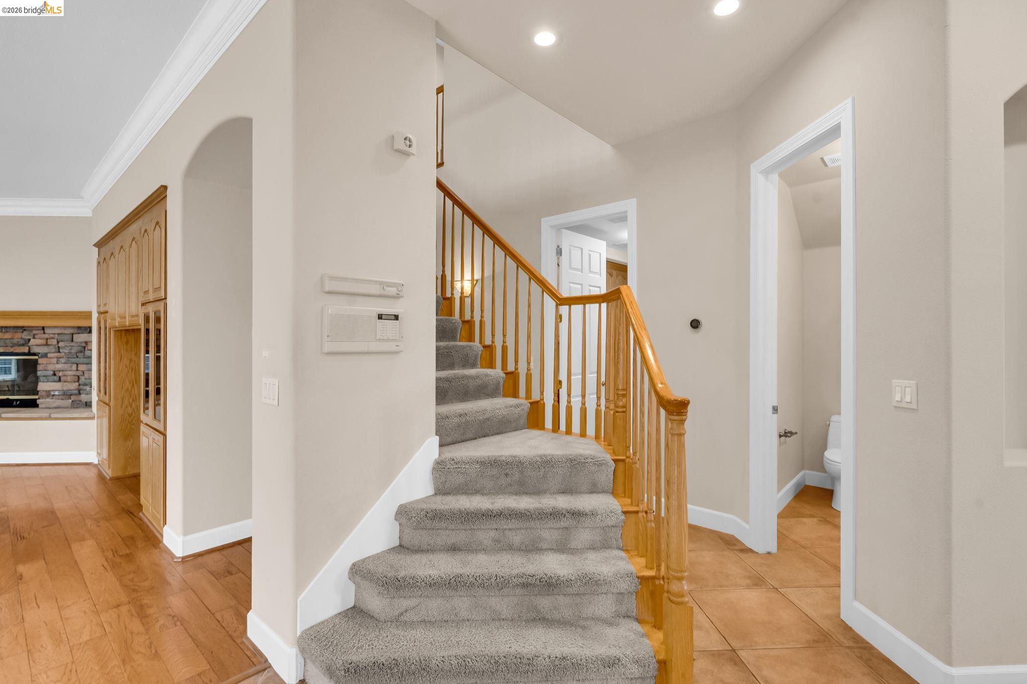5 Circle E Ranch Place San Ramon, CA 94583 - Photo 59 of 60 Stairway featuring arched walkways, ornamental molding, and a fireplace