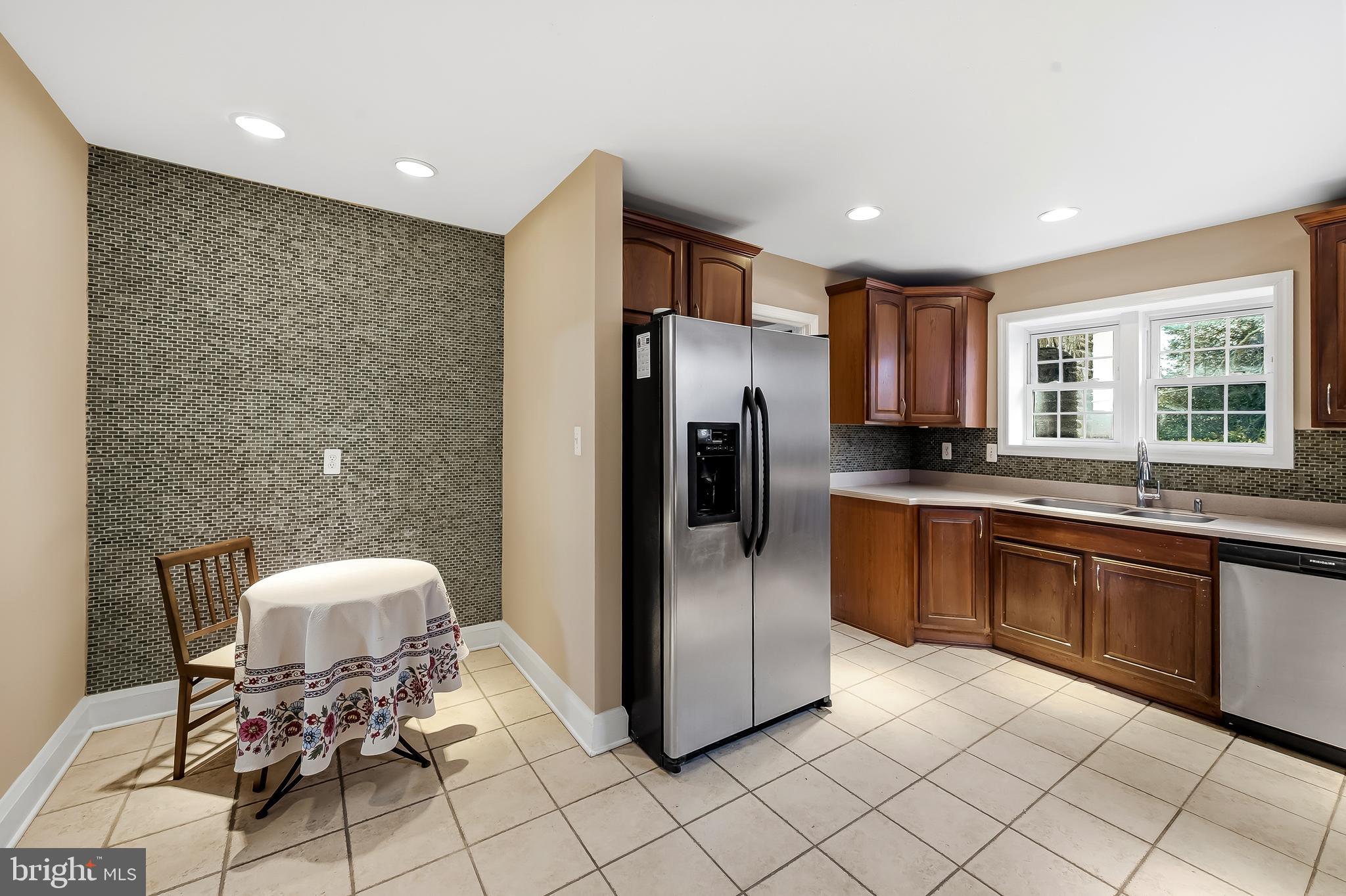 922 Fairway Drive Towson, MD 21286 - Photo 15 of 52 a kitchen with stainless steel appliances granite countertop a refrigerator and a sink