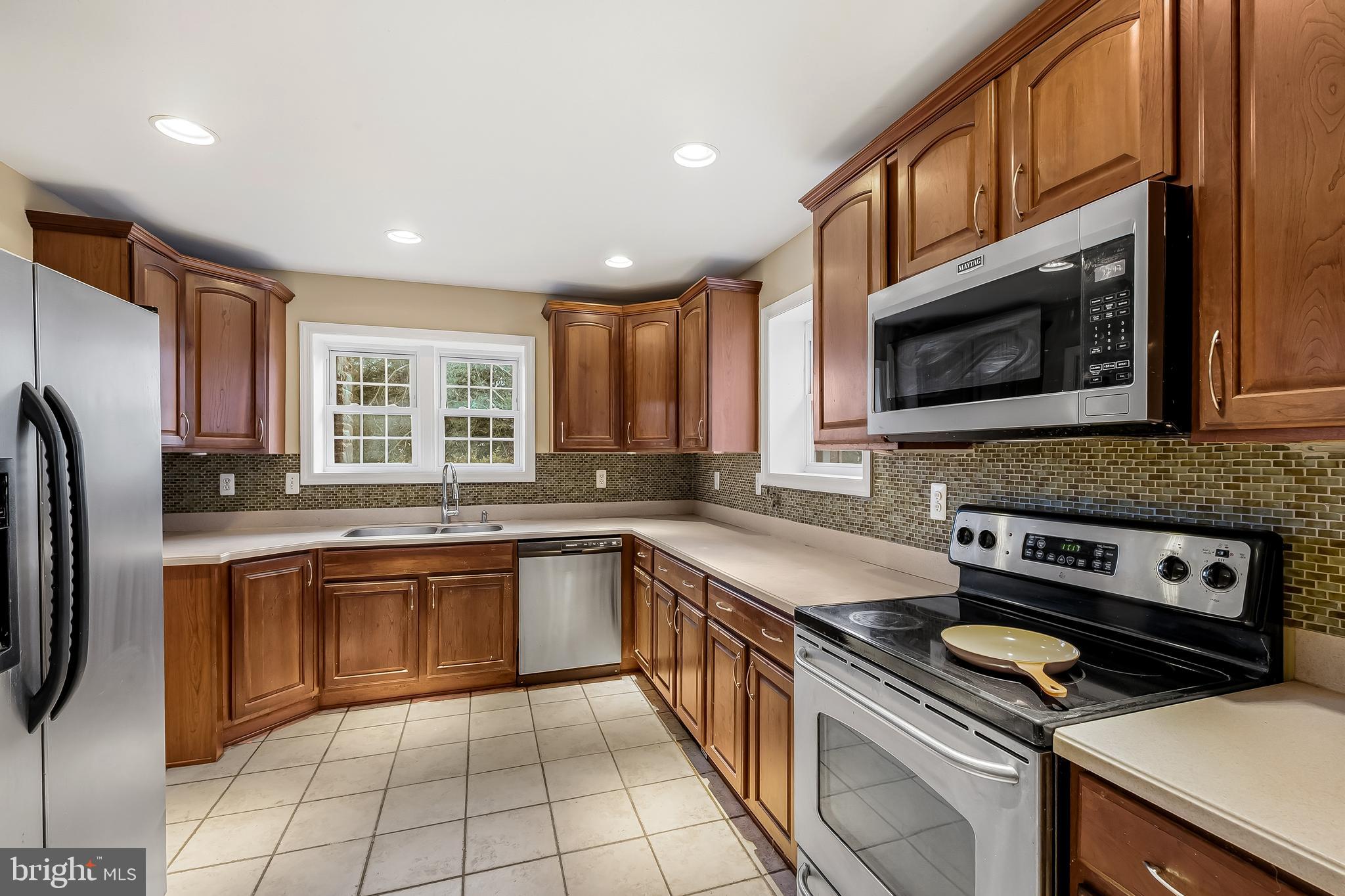 922 Fairway Drive Towson, MD 21286 - Photo 16 of 52 a kitchen with stainless steel appliances granite countertop a stove a sink and a microwave