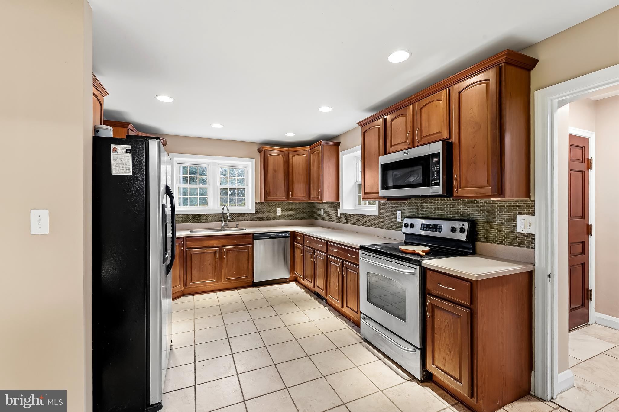 922 Fairway Drive Towson, MD 21286 - Photo 17 of 52 a kitchen with stainless steel appliances granite countertop a refrigerator and a stove top oven