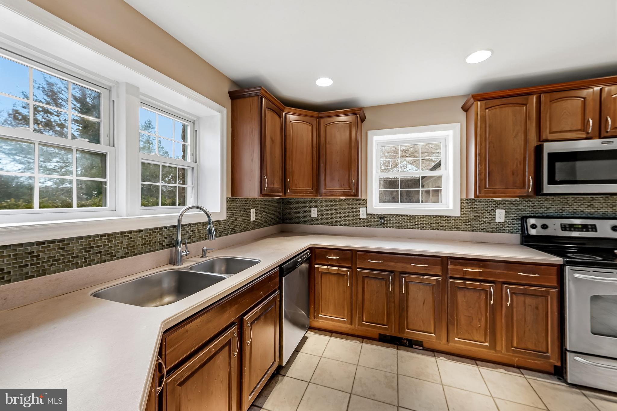 922 Fairway Drive Towson, MD 21286 - Photo 18 of 52 a kitchen that has a sink and a stove top oven