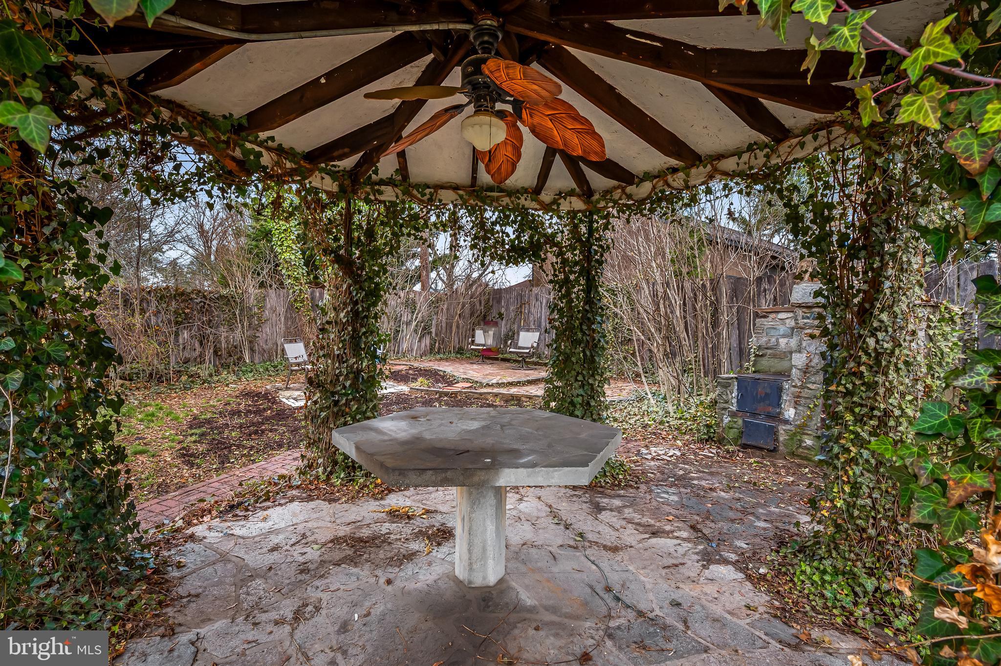 922 Fairway Drive Towson, MD 21286 - Photo 48 of 52 a view of a yard with table and chairs under an umbrella