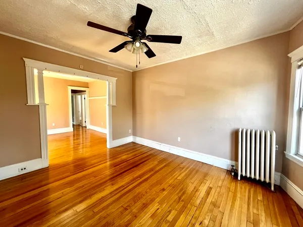 wooden floor in an empty room with a window
