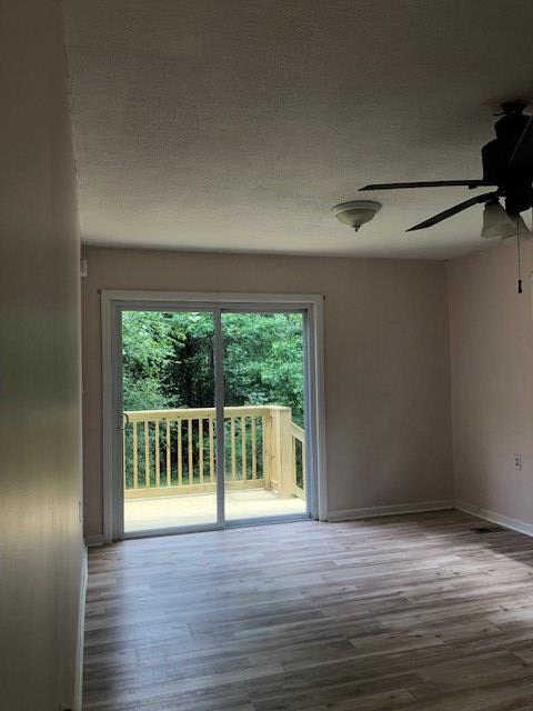 3685 Almond Road Fortson, GA 31808 - Photo 13 of 17 a view of empty room with wooden floor and fan