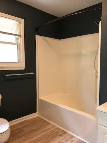 a bathroom with a bathtub and a shower