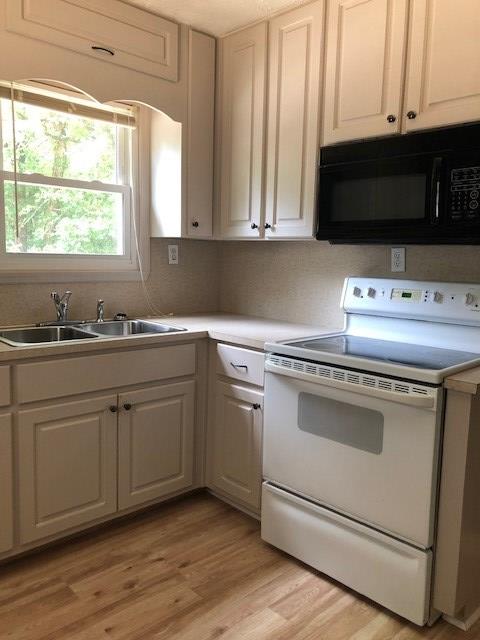 3685 Almond Road Fortson, GA 31808 - Photo 5 of 17 a kitchen with appliances a sink and a microwave