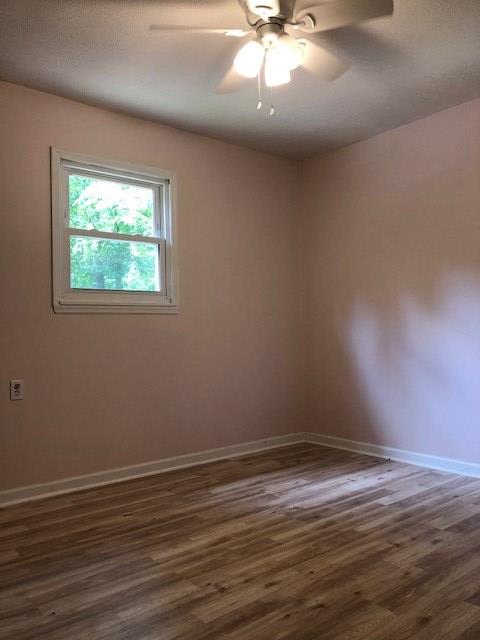 3685 Almond Road Fortson, GA 31808 - Photo 8 of 17 a view of an empty room with wooden floor and a window