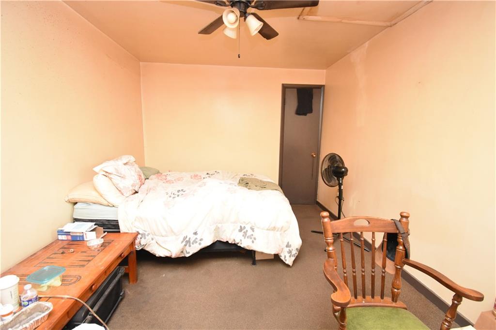 926 Island Avenue McKees Rocks, PA 15136 - Photo 5 of 21 a bedroom with bed and a chandelier
