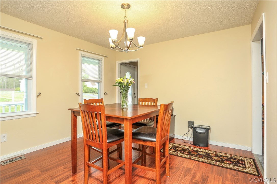 7463 Trailing Rock Road Prince George, VA 23875 - Photo 9 of 30 a view of a dining room with furniture and chandelier