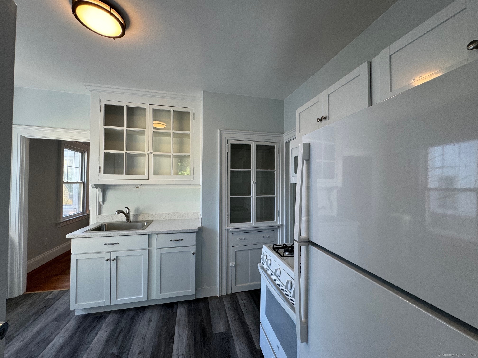 1253 Forest Road, Unit 2 New Haven, CT 06515 - Photo 21 of 30 a kitchen with a sink appliances and cabinets
