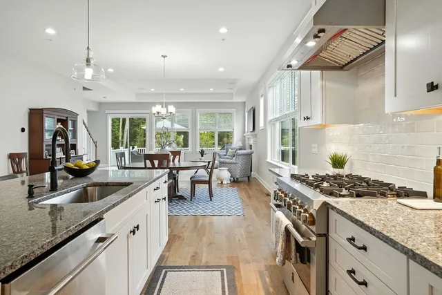 a kitchen with sink stove and cabinets