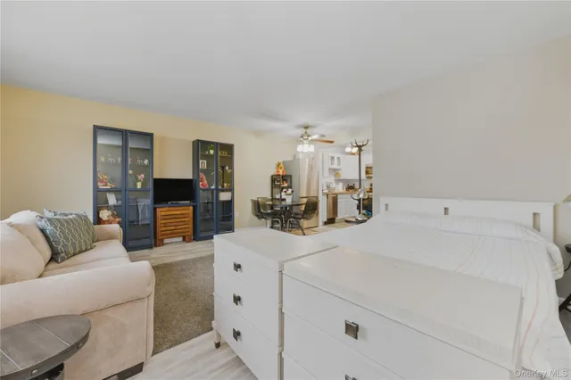 a living room with furniture and kitchen view