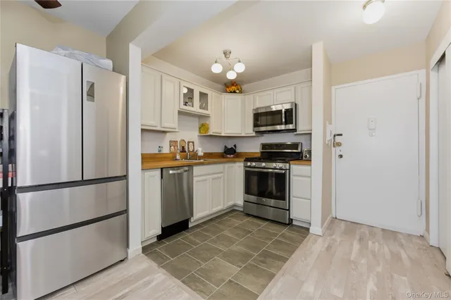 a kitchen with a refrigerator a stove top oven a sink and dishwasher