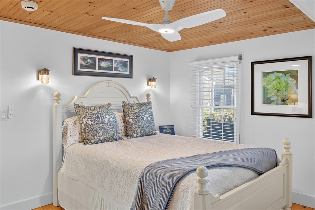 1145 Kingsbury Beach Road Eastham, MA 02642 - Photo 27 of 42 a bedroom with a large bed and a window