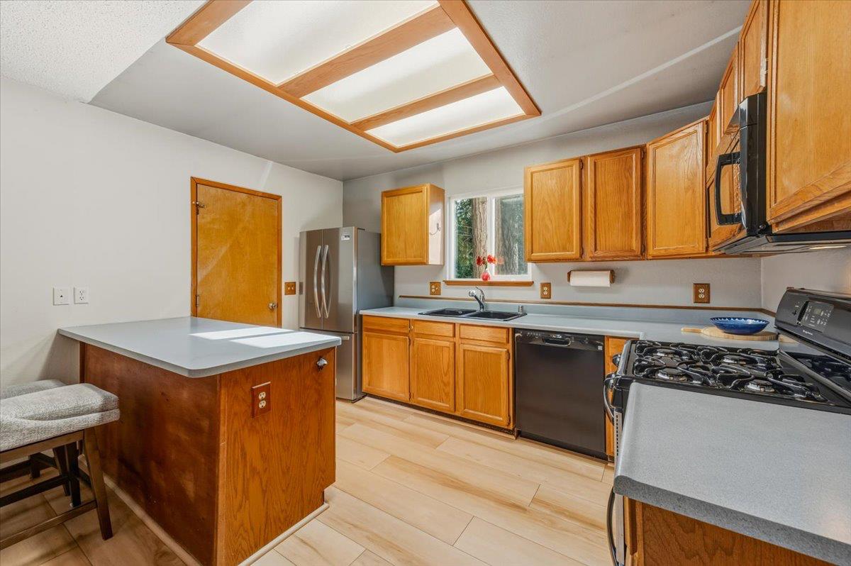12486 Valley View Road Nevada City, CA 95959 - Photo 13 of 48 a kitchen with stainless steel appliances granite countertop a stove a sink dishwasher and a refrigerator