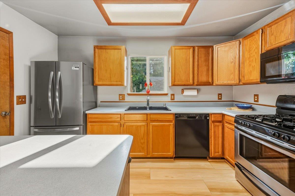 12486 Valley View Road Nevada City, CA 95959 - Photo 14 of 48 a kitchen with stainless steel appliances granite countertop a stove a sink and a refrigerator