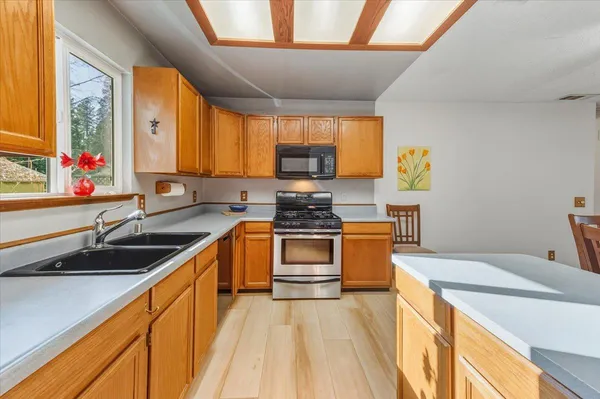 a kitchen that has a sink and a stove in it