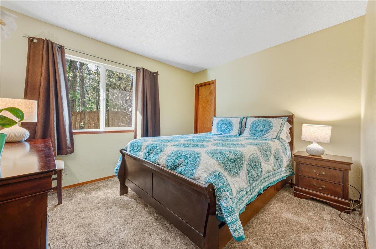 12486 Valley View Road Nevada City, CA 95959 - Photo 19 of 48 a bedroom with a bed and window